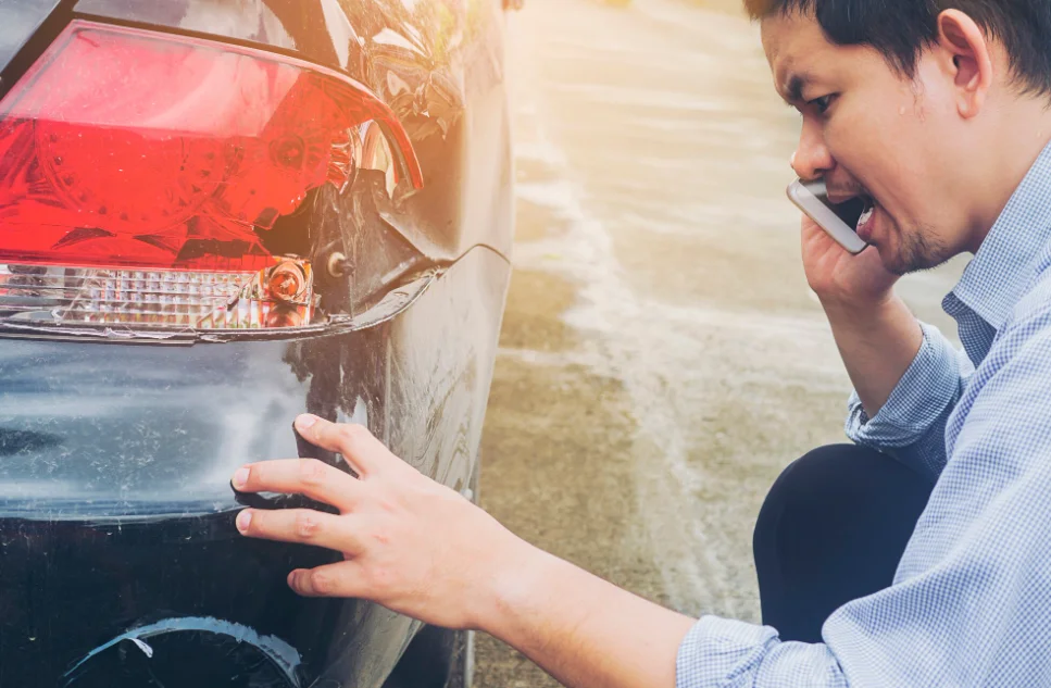 man is calling insurrance company for claiming his car crash damaged on road accident